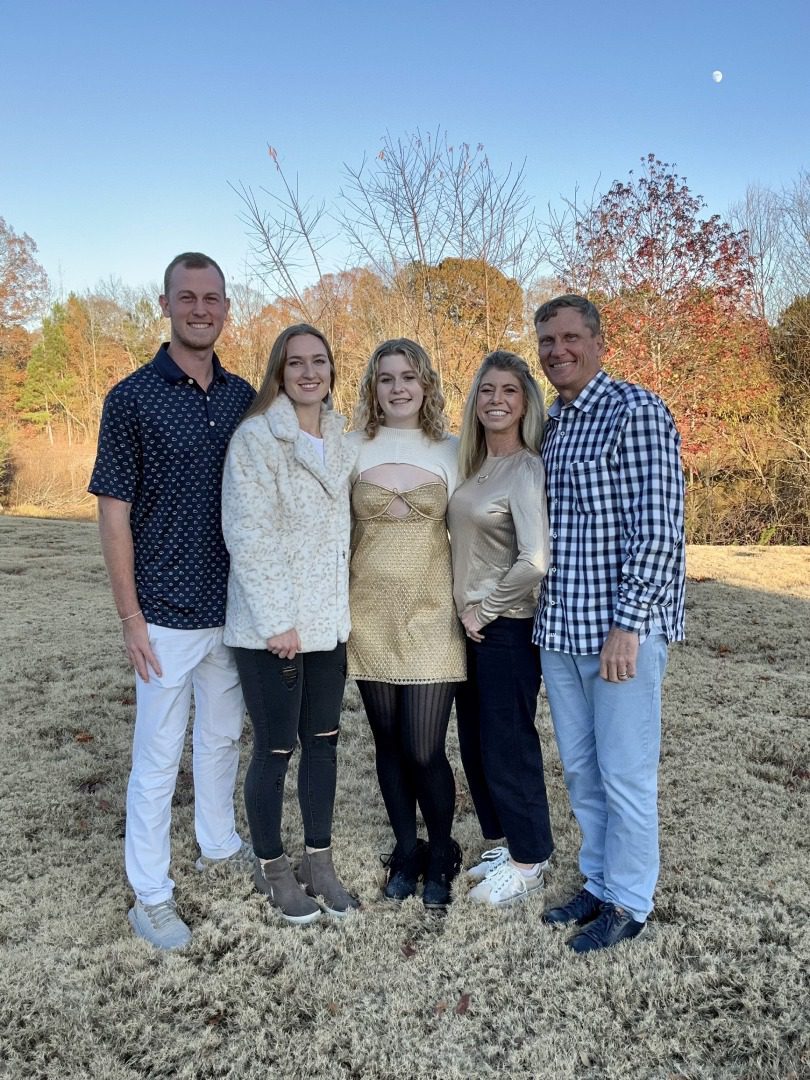 A group of people standing in the dirt.